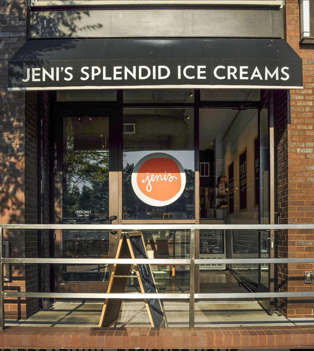 A cheerful storefront with eye-catching signage and a menu board, inviting families to enjoy unique ice cream flavors. The scene is lively, suggesting a neighborhood spot perfect for a sweet treat just steps away from home.